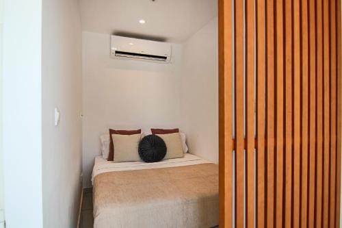 a small bedroom with a bed in a room at Phaedrus Living - Seaside Luxury Flat Harbour 102 in Paphos