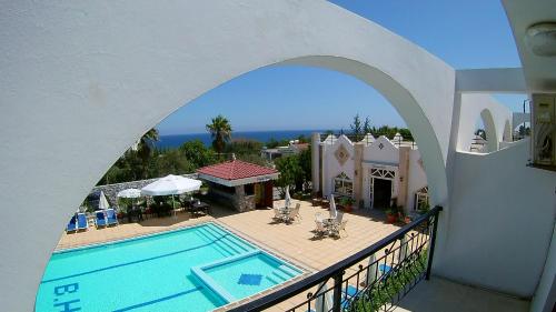 a view of a house with a swimming pool at Bare Hill Holiday Apartments in Kérynia