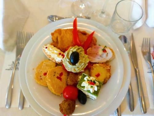 a white plate of food on a table at Hotel Mara in Baia Mare