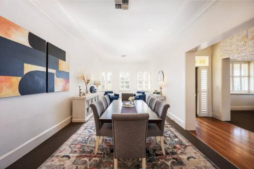 a dining room with a table and chairs at 'Micah House' A Central Mudgee Art Deco Hideaway in Mudgee