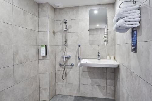 a bathroom with a shower and a sink at Kyriad Nancy Ouest - Laxou in Maxéville