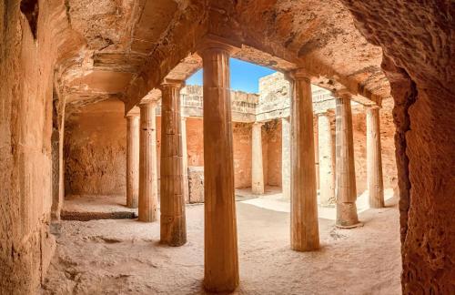 an arcade in the ruins of a building with columns at King Evelthon Beach Hotel & Resort in Paphos City