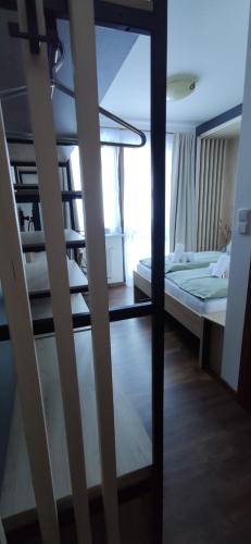 a bedroom with a bunk bed and a staircase at Pension Gemshorn in Hainzenberg