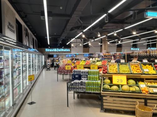 a grocery store aisle with fruits and vegetables on display at Apartman Stevan in Pirot