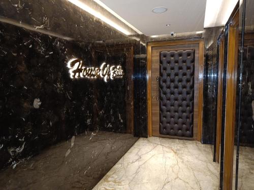 a room with a door and a wall with graffiti at The Kings Park Grand-Near US Consulate in Chennai