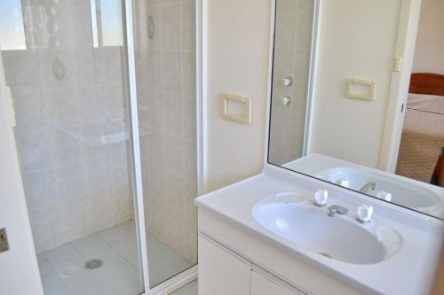 a bathroom with a sink and a shower at Beach Retreat in South West Rocks