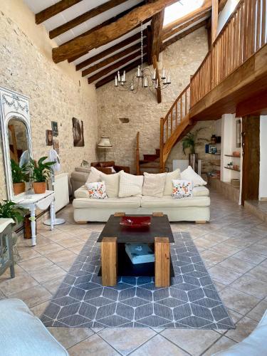 a living room with a couch and a table at Anahata Gite in Constant