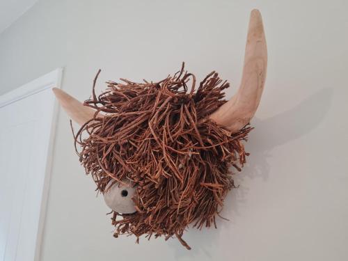 a cow head with horns on a white wall at The Farmhouse - Linton Horseheath in Linton