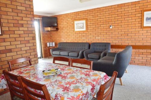 a room with a table and chairs and a couch at Cameo Court Unit 7 South West Rocks in South West Rocks