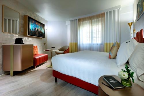 a hotel room with a bed and a desk and a room at Hard Rock Hotel Marbella - Puerto Banús in Marbella