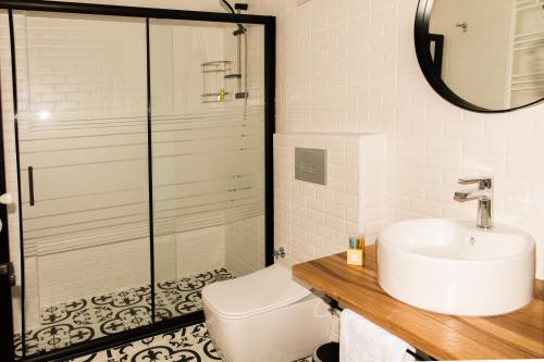 a bathroom with a sink and a toilet at Fidanoğlu Suite Hotel Çorlu in Corlu