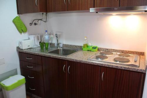 a kitchen with a stove and a sink in it at Zef's Cottage in São Vicente