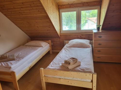 a bedroom with two beds in a attic at Dom Bystrá pod Chopkom & wellness in Bystrá