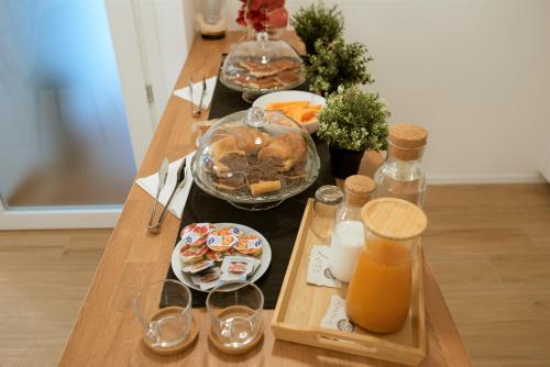 a table with several dishes of food and glasses on it at La Promessa in Santa Maria Nuova