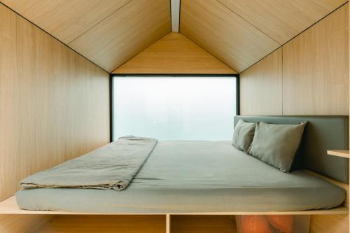 a bed in a small room with a window at Bobocabin Cikole, Bandung in Lembang