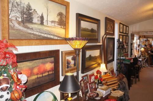 a living room with paintings on the wall at Greenbrier Inn Killington in Killington