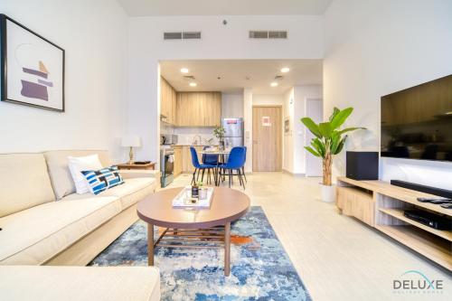 a living room with a couch and a table at Sophisticated 1BR at Town Square Rawda Dubailand by Deluxe Holiday Homes in Dubai