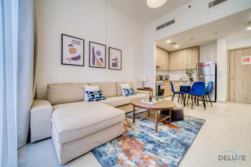 a living room with a couch and a table at Sophisticated 1BR at Town Square Rawda Dubailand by Deluxe Holiday Homes in Dubai