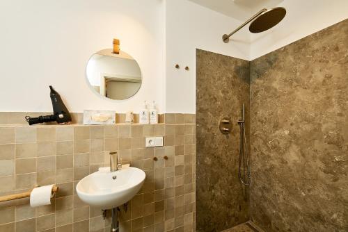a bathroom with a sink and a shower at Landhaus Wehlener Klosterberg in Bernkastel-Kues