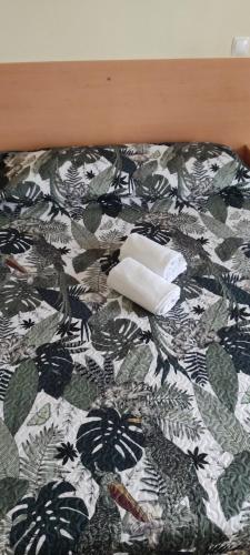 a bed with a black and white comforter at Alojamento Local Pensão Rossio in Lisbon