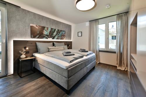 a bedroom with a large bed and a large window at BergCrystal in Garmisch-Partenkirchen