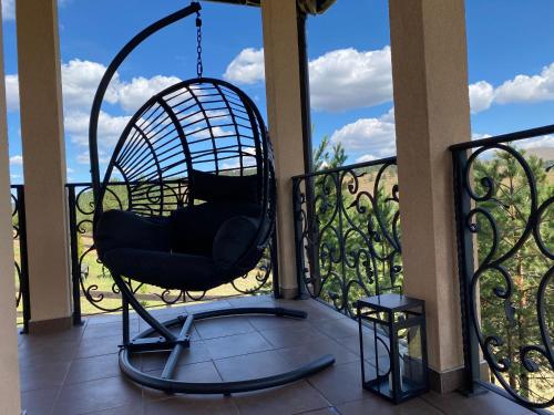 a swing on the balcony of a house at Vila Čarna Zlatibor in Zlatibor