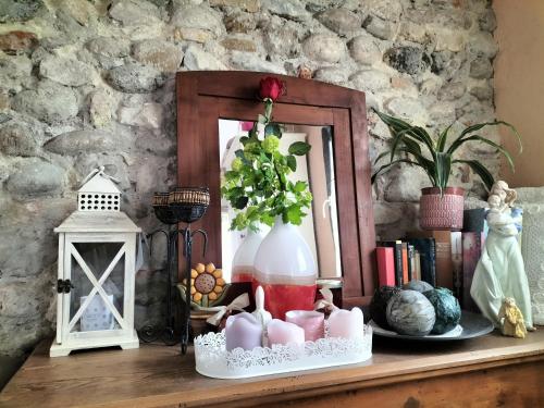 a table with a vase and other items on it at B&B Terre Di Bea in Pederobba