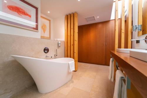 a large white bath tub in a bathroom at Hotel Rural S'Olivaret & Spa in Alaró