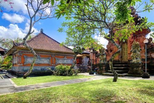 an old building with trees in front of it at Jero Delod Guesthouse in Tabanan