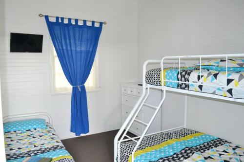 a bedroom with a bunk bed and a ladder at Rockleigh in South West Rocks