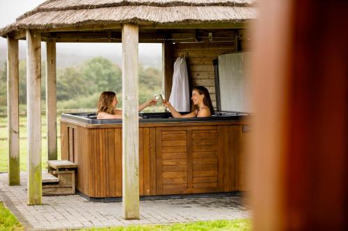 two women in a hot tub in a gazebo at Mulberry House in Swansea