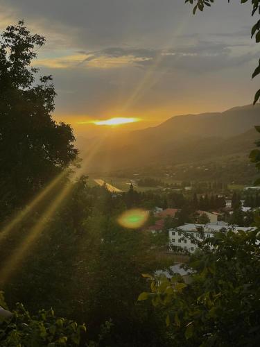 a view of the sun setting over a city at View Racha in Ambrolauri