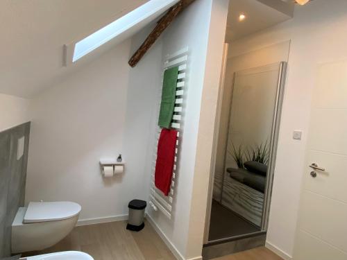 a bathroom with a toilet and a sink and a window at Gästehaus Rheinromantik in Bacharach