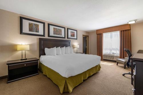 a hotel room with a large bed and a window at Best Western Bonnyville Inn & Suites in Bonnyville