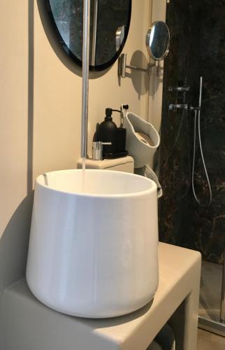 a white sink in a bathroom with a mirror at QUIRICO GUEST HOUSE in Locorotondo