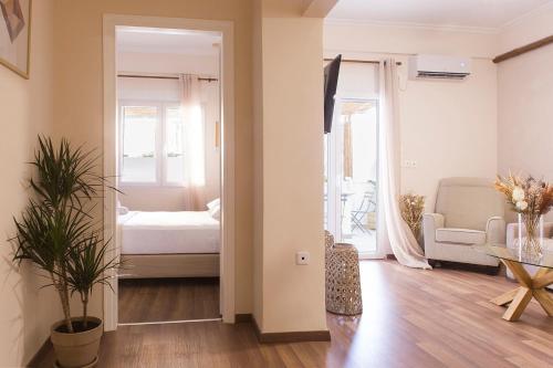 a living room with a bed and a table at Luxury Apartment with Jacuzzi Close to Acropolis - Living Stone Zircon in Athens