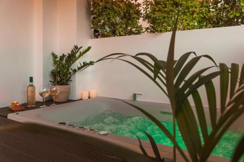 a bath tub with a potted plant in a bathroom at Luxury Apartment with Jacuzzi Close to Acropolis - Living Stone Zircon in Athens
