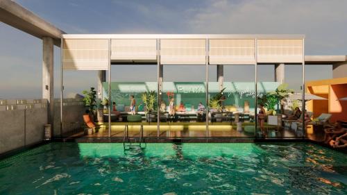 a swimming pool in front of a hotel at Zone By The Park Gopalpur in Gopālpur