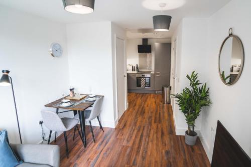 a living room with a dining room table and a kitchen at Modern 1-Bed Apartments - New - City Centre - FREE Wi-Fi - in Sheffield