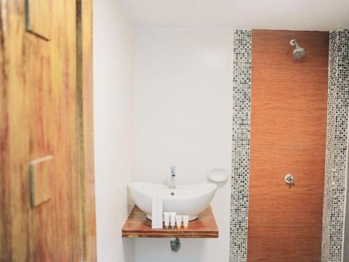 a bathroom with a white sink in a room at Villa Excellance Beach and Wave Pool Resort in Postema