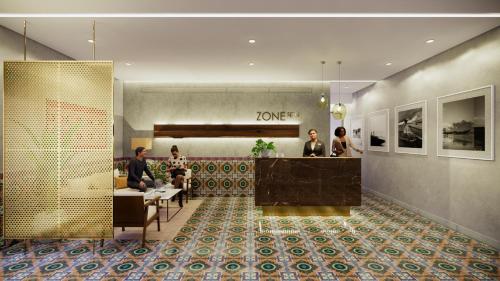 a lobby with people sitting at tables in a room at Zone By The Park Gopalpur in Gopālpur