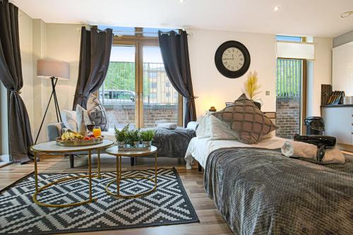 a living room with a couch and a table at Campbell Park Apartment - City Centre - Free Parking, Balcony, Super-Fast Wifi and Smart TV with Netflix by Yoko Property in Milton Keynes