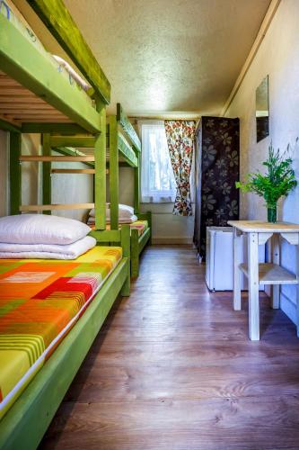 a room with two bunk beds and a table at Po Švyturiu in Šventoji