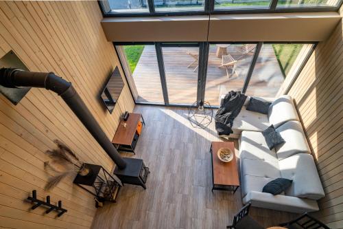 an overhead view of a living room with a white couch at Hytte Na Wyspie -,,Roztoczańskie Morze'' in Kulików