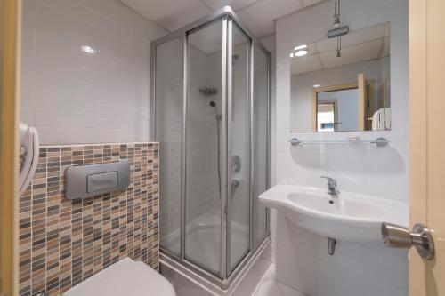 La salle de bains est pourvue d'une douche et d'un lavabo. dans l'établissement Seckin Konaklar, à Bodrum City