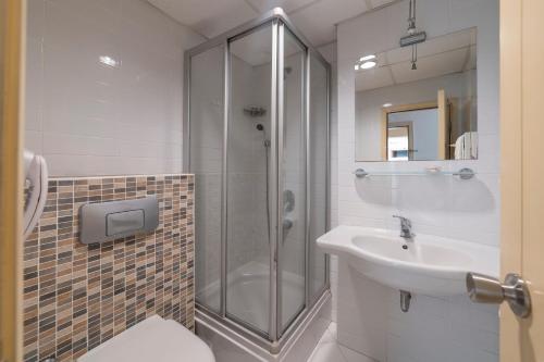 a bathroom with a shower and a sink at Seckin Konaklar in Bodrum City