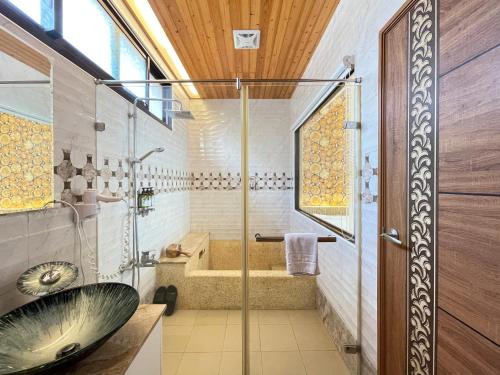 a bathroom with a shower and a sink and a tub at Jabez II in Jiaoxi
