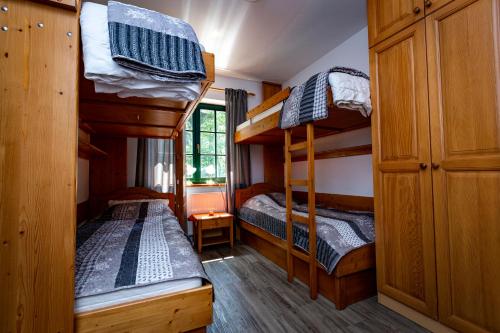 a bedroom with two bunk beds in a cabin at Prijeten sončen apartma v objemu Pohorja in Zgornje Hoče