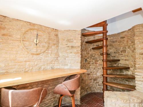 a staircase in a room with a brick wall at Steel Works Farm in Ross on Wye