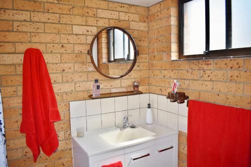 a bathroom with a sink and a mirror at Seacrest 5 South West Rocks in South West Rocks